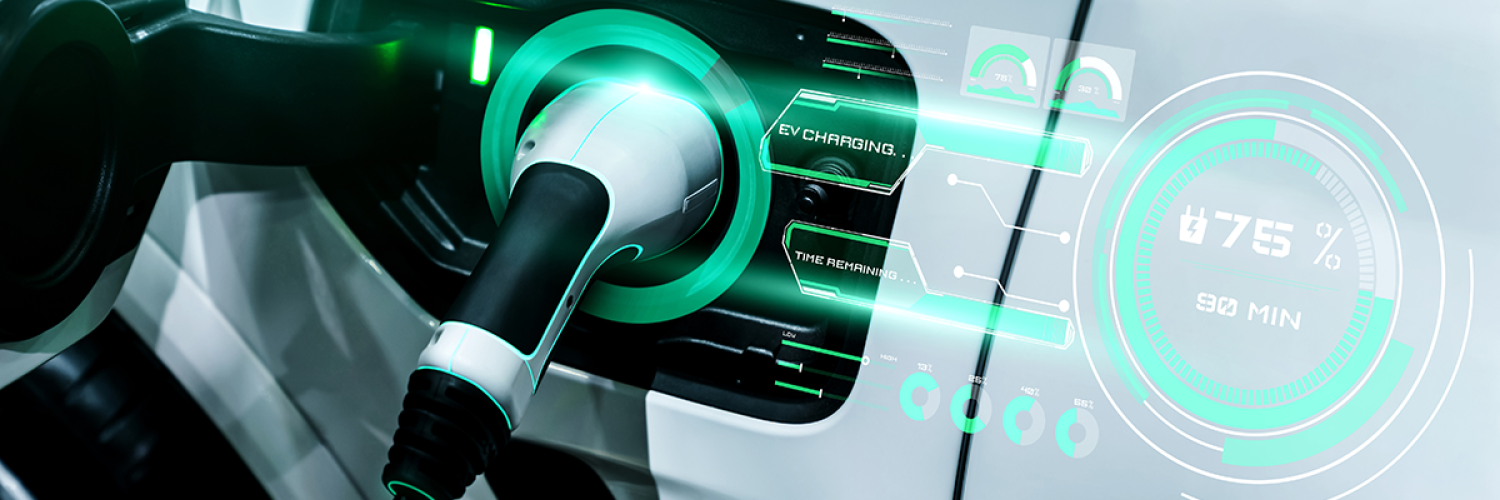 a close up view of a charging port of an electrified vehicle with the charger plugged in. The car is white and there are green elements written about charging data 