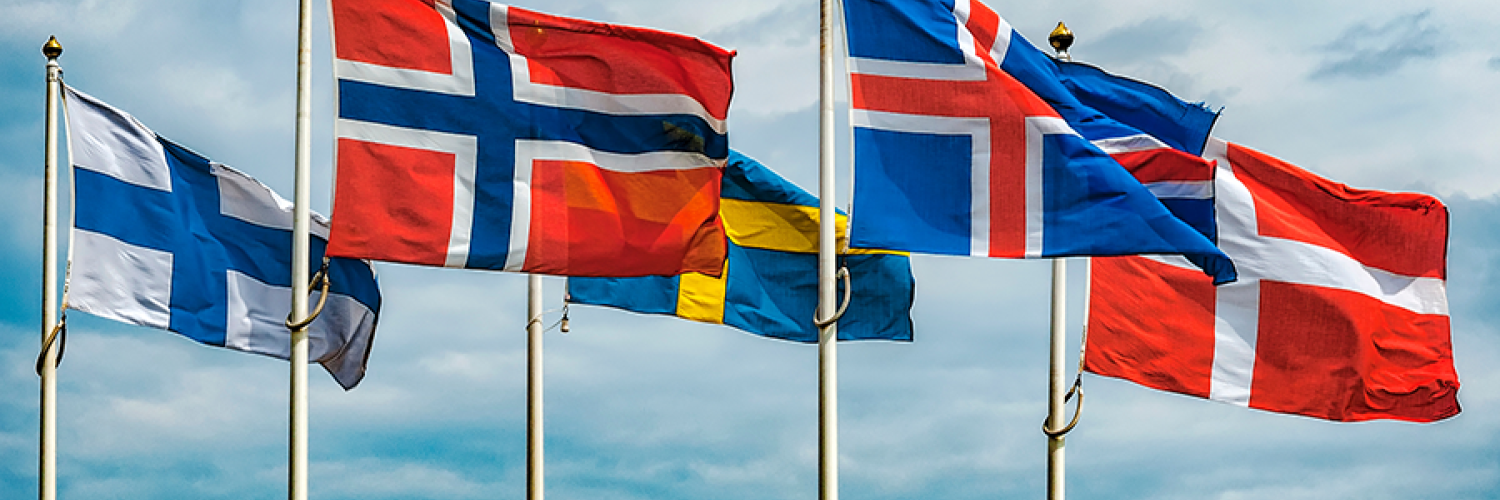 flags from all nordics countries aligned on masts with the sky in the background