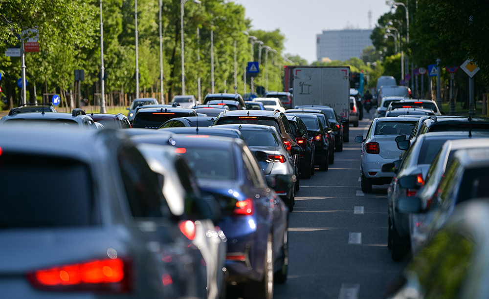 a picture of many vehicles in traffic at a stop in a city in Romania